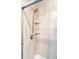 Close-up of a shower featuring brushed nickel fixtures and corner shelving at 5511 Colonial Chatsworth Cir, North Charleston, SC 29418