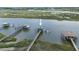 Aerial view of a walkway leading to private covered dock with a waterfront backdrop, creating an oasis at 627 Barbados Dr, Charleston, SC 29492