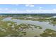 Beautiful aerial view of marshland waterway lined with green landscape and waterfront homes at 627 Barbados Dr, Charleston, SC 29492