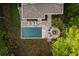 Overhead view of backyard featuring a pool, lounge area, fire pit, and manicured lawn at 627 Barbados Dr, Charleston, SC 29492