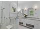 Bright bathroom featuring double sinks, marble counters, and a tiled shower at 627 Barbados Dr, Charleston, SC 29492