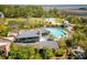 Aerial view of a luxurious community pool surrounded by lush landscaping and a clubhouse at 627 Barbados Dr, Charleston, SC 29492