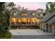 Inviting two-story home with a charming front porch, well-lit windows, and manicured landscaping at 627 Barbados Dr, Charleston, SC 29492