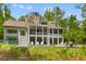 Beautiful rear exterior view of a multi-level home with an inviting pool and well-manicured lawn at 627 Barbados Dr, Charleston, SC 29492