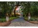 Charming home nestled among mature trees, featuring a welcoming driveway and brick entrance at 627 Barbados Dr, Charleston, SC 29492