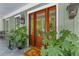 Charming home entrance with wood doors, stylish outdoor lighting, and lush landscaping for curb appeal at 627 Barbados Dr, Charleston, SC 29492