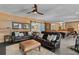 Spacious game room with wood paneled walls, leather couches, and a pool table at 627 Barbados Dr, Charleston, SC 29492