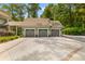 Large three-car garage with a spacious driveway and beautiful landscaping at 627 Barbados Dr, Charleston, SC 29492