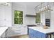 Bright kitchen featuring a central island with book shelves, a gas range, and ample counter space at 627 Barbados Dr, Charleston, SC 29492