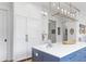 Chic kitchen features a marble island with a sink, white cabinets and stainless steel appliances at 627 Barbados Dr, Charleston, SC 29492
