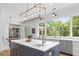 Elegant kitchen featuring a large island with a sink, bright lighting, and a large window with a view at 627 Barbados Dr, Charleston, SC 29492