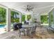 Covered patio with travertine floors, ceiling fan, dining table, and views of the pool at 627 Barbados Dr, Charleston, SC 29492