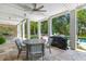 Covered patio with travertine floors, outdoor dining, grill, and view of the pool and yard at 627 Barbados Dr, Charleston, SC 29492