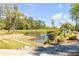 Picturesque pond bordered by lush trees and manicured grounds, creating a serene waterfront setting at 627 Barbados Dr, Charleston, SC 29492