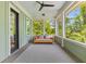 Inviting screened porch with a daybed swing and wooded views at 627 Barbados Dr, Charleston, SC 29492