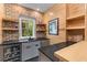 Wet bar features a brick accent wall, custom cabinetry, and granite countertops at 627 Barbados Dr, Charleston, SC 29492