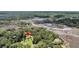 Expansive aerial view highlighting the lush, wooded surroundings near a marshland with direct road access at 7274 Commodore Rd, Hollywood, SC 29449