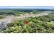 Scenic aerial shot presenting a home nestled in a flourishing, tree-filled area alongside a scenic water feature at 7274 Commodore Rd, Hollywood, SC 29449