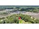 Aerial perspective showcasing the property's placement within dense greenery, beside a unique waterway landscape at 7274 Commodore Rd, Hollywood, SC 29449