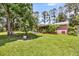 Expansive backyard featuring a well-maintained lawn and mature trees, perfect for outdoor activities at 7274 Commodore Rd, Hollywood, SC 29449