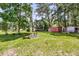 Expansive backyard with mature trees, fire pit, and shed providing a serene outdoor space at 7274 Commodore Rd, Hollywood, SC 29449
