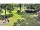 Expansive backyard with manicured lawn, outdoor entertainment area, and mature trees at 7274 Commodore Rd, Hollywood, SC 29449