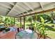 Charming backyard with a covered patio, lush greenery, and an outdoor dining area at 7274 Commodore Rd, Hollywood, SC 29449