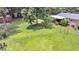 Lush backyard featuring a well-kept lawn, mature trees, and covered deck, with home extending into view at 7274 Commodore Rd, Hollywood, SC 29449