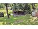 Aerial shot of an organized backyard including sheltered area for cooking, landscaping, and storage at 7274 Commodore Rd, Hollywood, SC 29449