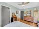 Bedroom with hardwood floors, ceiling fan, ample storage, and decorative touches at 7274 Commodore Rd, Hollywood, SC 29449