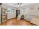 Bright bedroom with hardwood floors, natural light, a comfortable chair, and ample storage at 7274 Commodore Rd, Hollywood, SC 29449