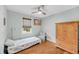 Cozy bedroom featuring a twin bed, hardwood floors, a window, and wood furnishings at 7274 Commodore Rd, Hollywood, SC 29449