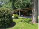Open carport area with gravel floor and rustic wood supports at 7274 Commodore Rd, Hollywood, SC 29449