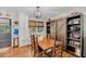 Dining room featuring a wooden table, chairs, windows with blinds, and custom cabinets and shelving at 7274 Commodore Rd, Hollywood, SC 29449