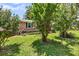 Well-kept brick home framed by lush greenery, highlighting the home's curb appeal at 7274 Commodore Rd, Hollywood, SC 29449
