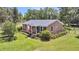 Charming brick home with well-maintained lawn, pretty shrubbery, and an American flag waving at 7274 Commodore Rd, Hollywood, SC 29449