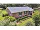 Charming brick home with well-maintained lawn, pretty shrubbery, and blue shutters at 7274 Commodore Rd, Hollywood, SC 29449