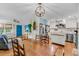 Open kitchen and dining area with wooden table, chairs, stainless appliances, and modern cabinetry at 7274 Commodore Rd, Hollywood, SC 29449