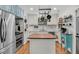 Bright kitchen featuring white cabinetry, stainless steel appliances, a butcher block island, and a hanging pot rack at 7274 Commodore Rd, Hollywood, SC 29449