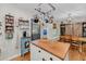 Bright kitchen featuring a wooden island, custom cabinetry, a breakfast nook, and stainless steel appliances at 7274 Commodore Rd, Hollywood, SC 29449