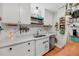 Updated kitchen with quartz countertops, stainless steel appliances, and custom white cabinetry, with open shelving at 7274 Commodore Rd, Hollywood, SC 29449