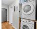 Efficient laundry room with a stacked washer and dryer and practical storage solutions at 7274 Commodore Rd, Hollywood, SC 29449