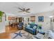 Cozy living room featuring nautical themed decor, ceiling fan and a dining area with natural light at 7274 Commodore Rd, Hollywood, SC 29449