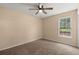 Bedroom with plush carpet, neutral walls, ceiling fan, and large window at 8116 Long Shadow Ln, North Charleston, SC 29406