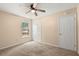Bedroom featuring plush carpeting, ceiling fan, and a window with a view to the outdoors at 8116 Long Shadow Ln, North Charleston, SC 29406