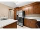 Traditional kitchen featuring wood cabinets, stainless steel refrigerator, and bright white countertops at 8116 Long Shadow Ln, North Charleston, SC 29406