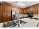 Open kitchen featuring stainless steel appliances, wood cabinets and an island with a sink at 8116 Long Shadow Ln, North Charleston, SC 29406