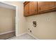 Laundry area with tile flooring, neutral paint and overhead cabinets for storage at 8116 Long Shadow Ln, North Charleston, SC 29406