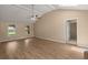 Bright living room with wood floors, ceiling fan, and several windows for ample natural light at 8116 Long Shadow Ln, North Charleston, SC 29406