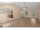 Open-concept living room with wood floors, wet bar, brick fireplace, and ample natural light at 8116 Long Shadow Ln, North Charleston, SC 29406